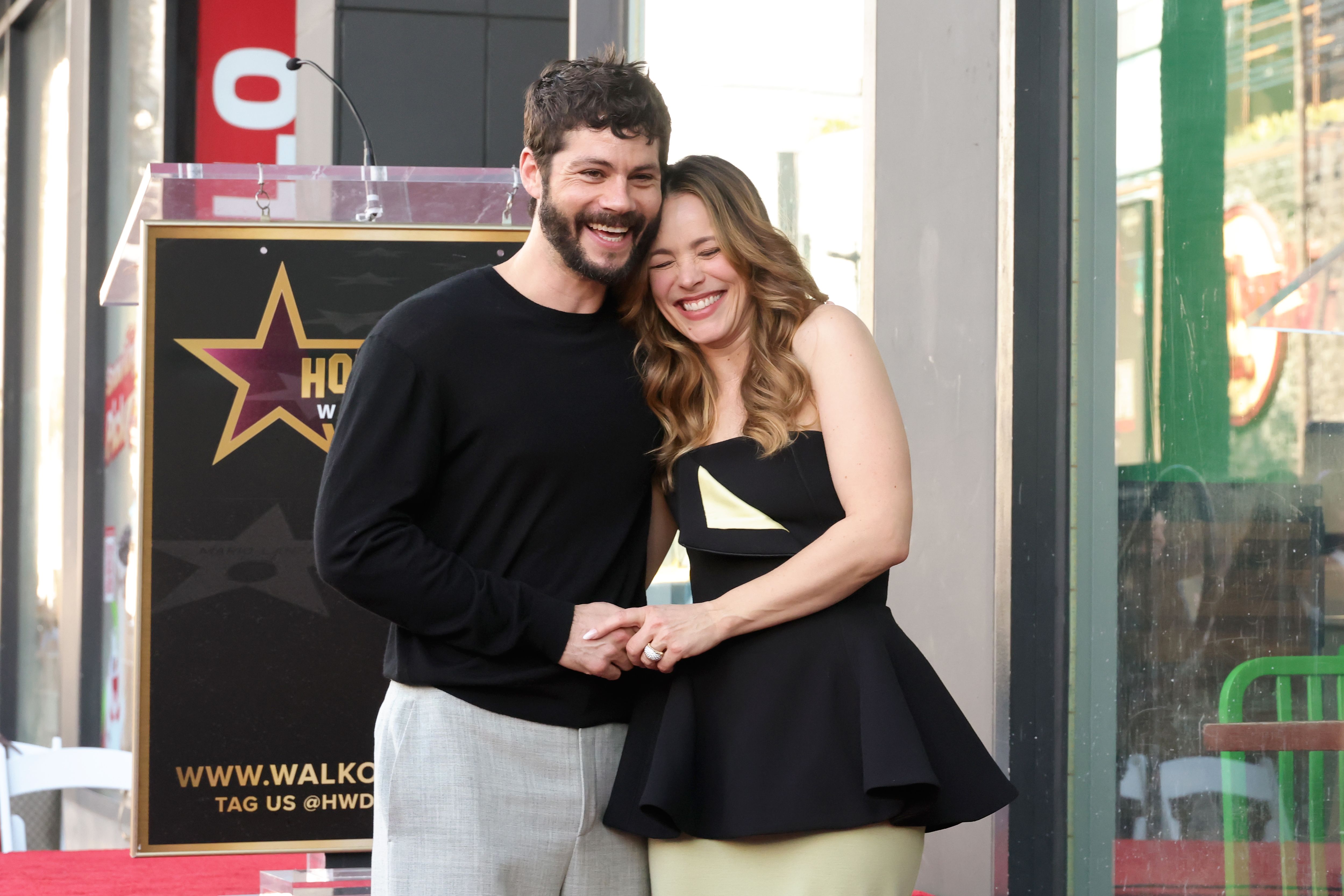 Dylan O'Brien and Rachel McAdams share a side hug at the Walk of Fame ceremony.