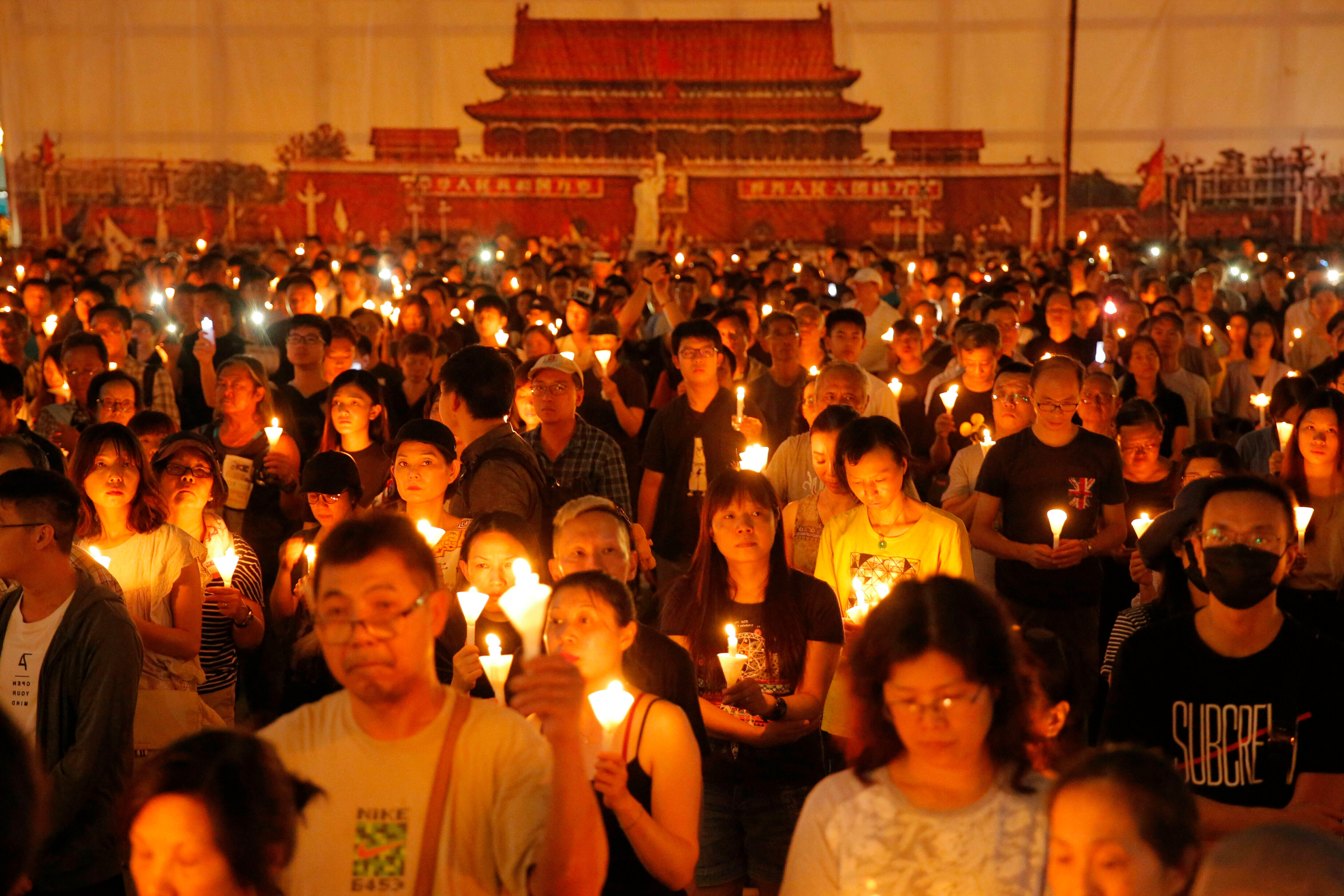 FILE - Thousands of people attend a candlelight vigil for victims of the Chinese government's brutal military crackdown three decades ago on protesters in Beijing's Tiananmen Square at Victoria Park in Hong Kong, June 4, 2019. (AP Photo/Kin Cheung, File)