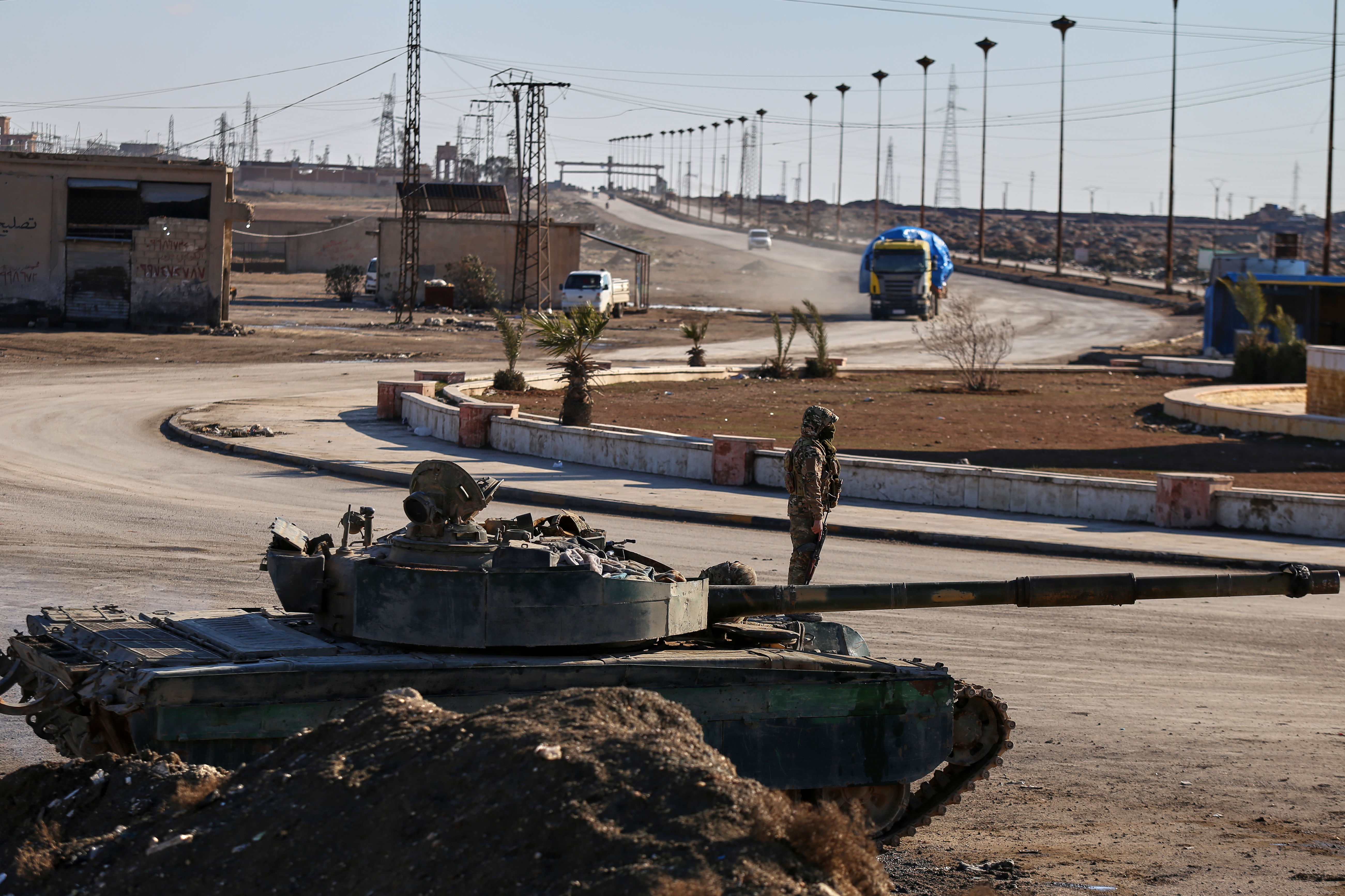 Soldiers of the Kurdish-led, U.S.-backed Syrian Democratic Forces (SDF) deploy with armoured military vehicles to secure roads leading to Gweiran Prison which houses men accused of being an Islamic State (ISIS) fighters in Hassakeh, northeastern Syria, Monday, Jan. 19, 2026. (AP Photo/Baderkhan Ahmad)