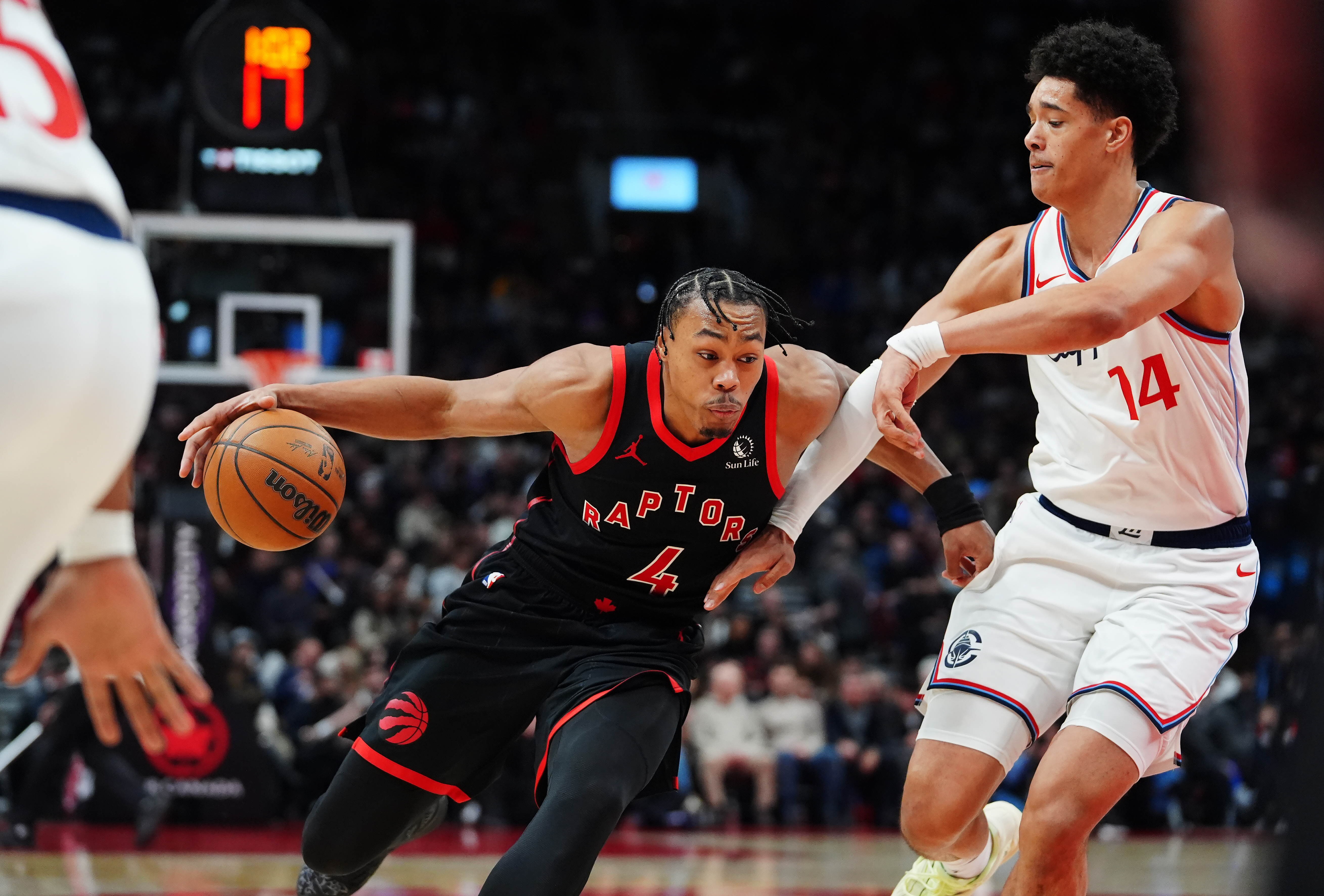 Scottie Barnes drives past Clippers rookie Yanic Konan Niederhauser