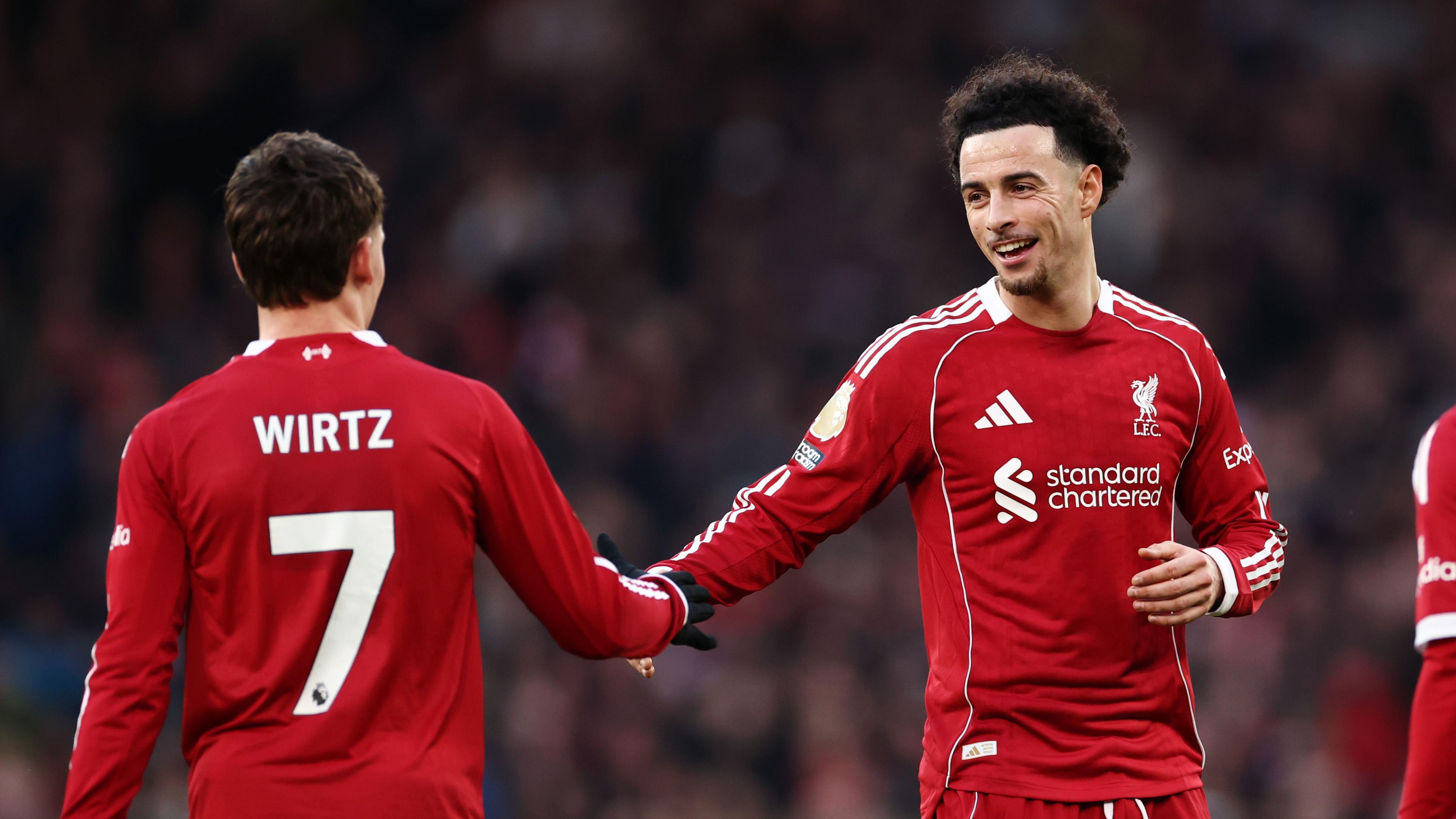 Curtis Jones smiles at Florian Wirtz during match