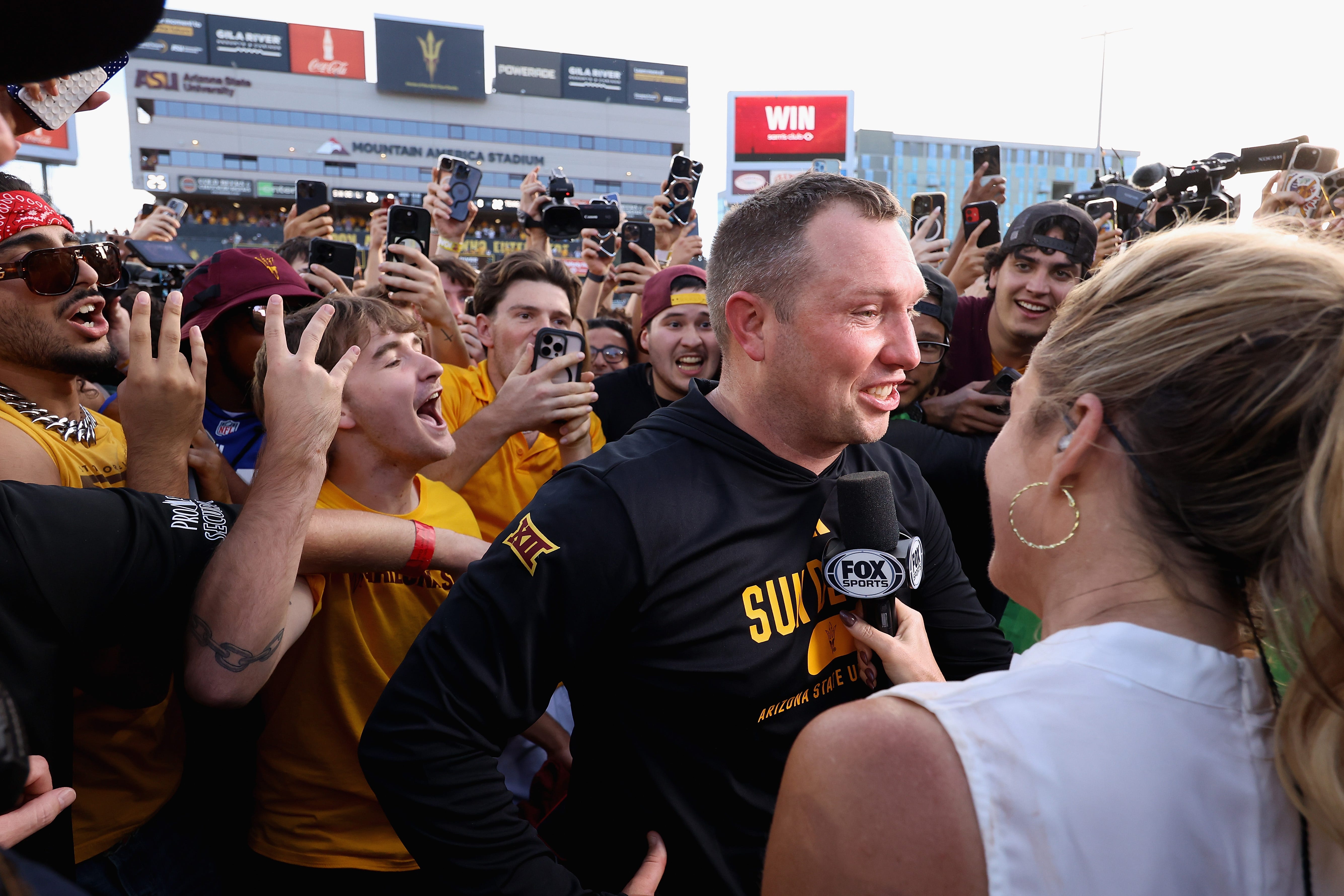 Head coach Kenny Dillingham of the Arizona State Sun Devils is interviewed by Fox Sports' Jen Hale after the Sun Devils defeated the Red Raiders 26-22 in a game at Mountain America Stadium on Oct. 18, 2025, in Tempe, Arizona.