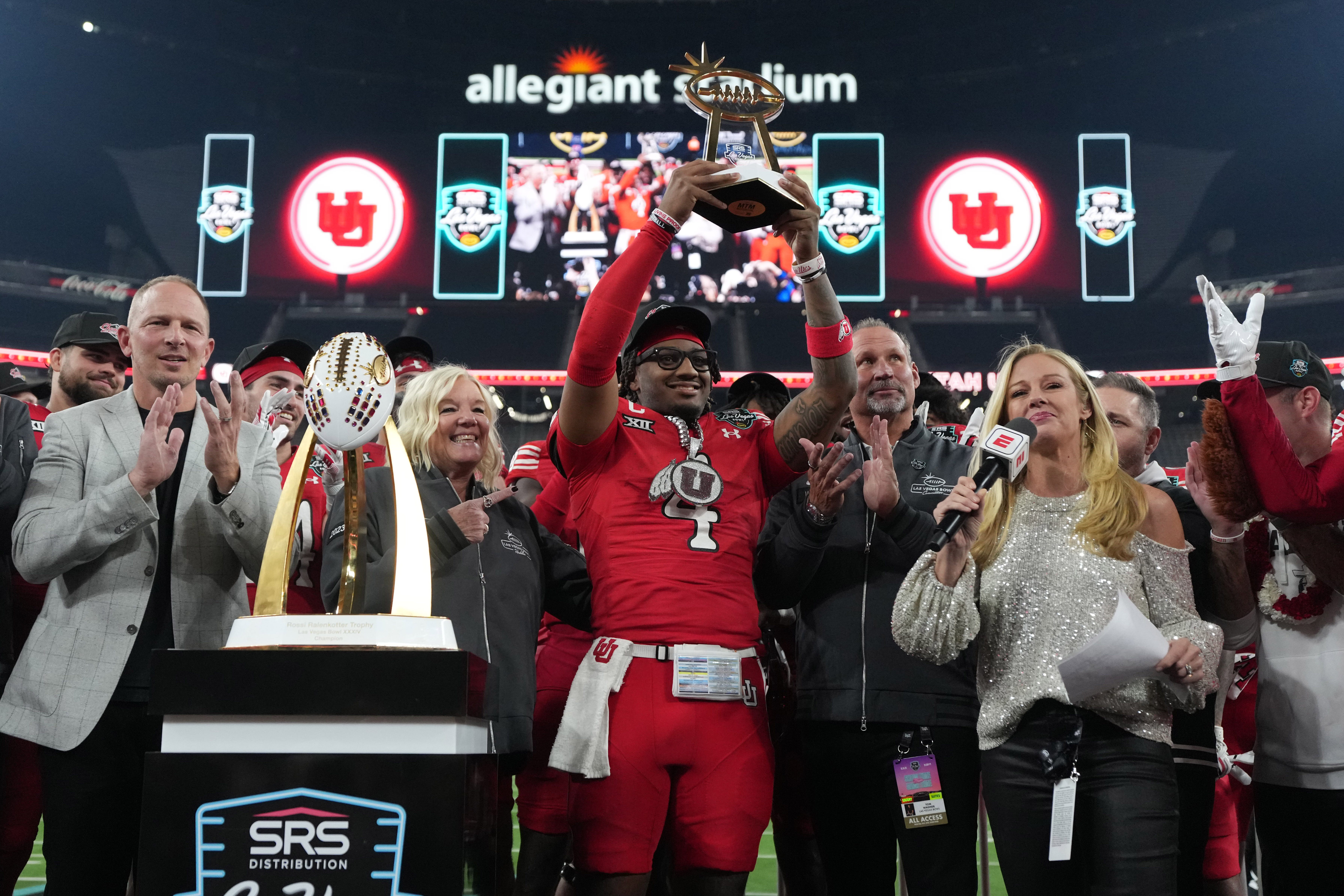 Dec 31, 2025; Las Vegas, NV, USA; Utah Utes quarterback Devon Dampier (4) holds the most valuable player trophy after victory over Nebraska Cornhuskers in the SRS Distribution Las Vegas Bowl at Allegiant Stadium. Mandatory Credit: Kirby Lee-Imagn Images