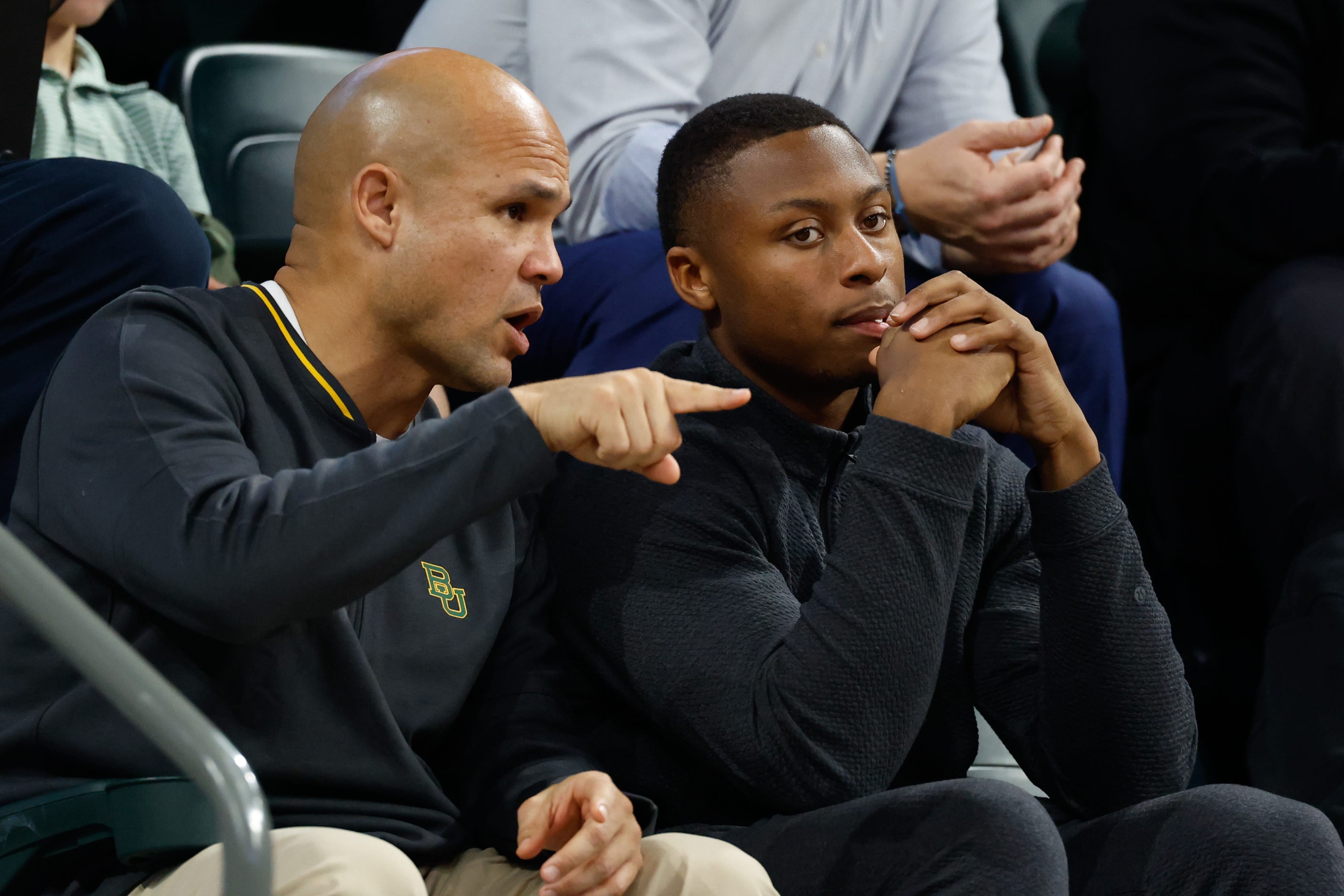 Jan 7, 2026; Waco, Texas, USA; DJ Lagway, a Florida quarterback currently in the transfer portal, sits with Baylor Bears football head coach Dave Aranda, left, during the first half of a game between the Baylor Bears and Iowa State Cyclones at Paul and Alejandra Foster Pavilion. Mandatory Credit: Chris Jones-Imagn Images