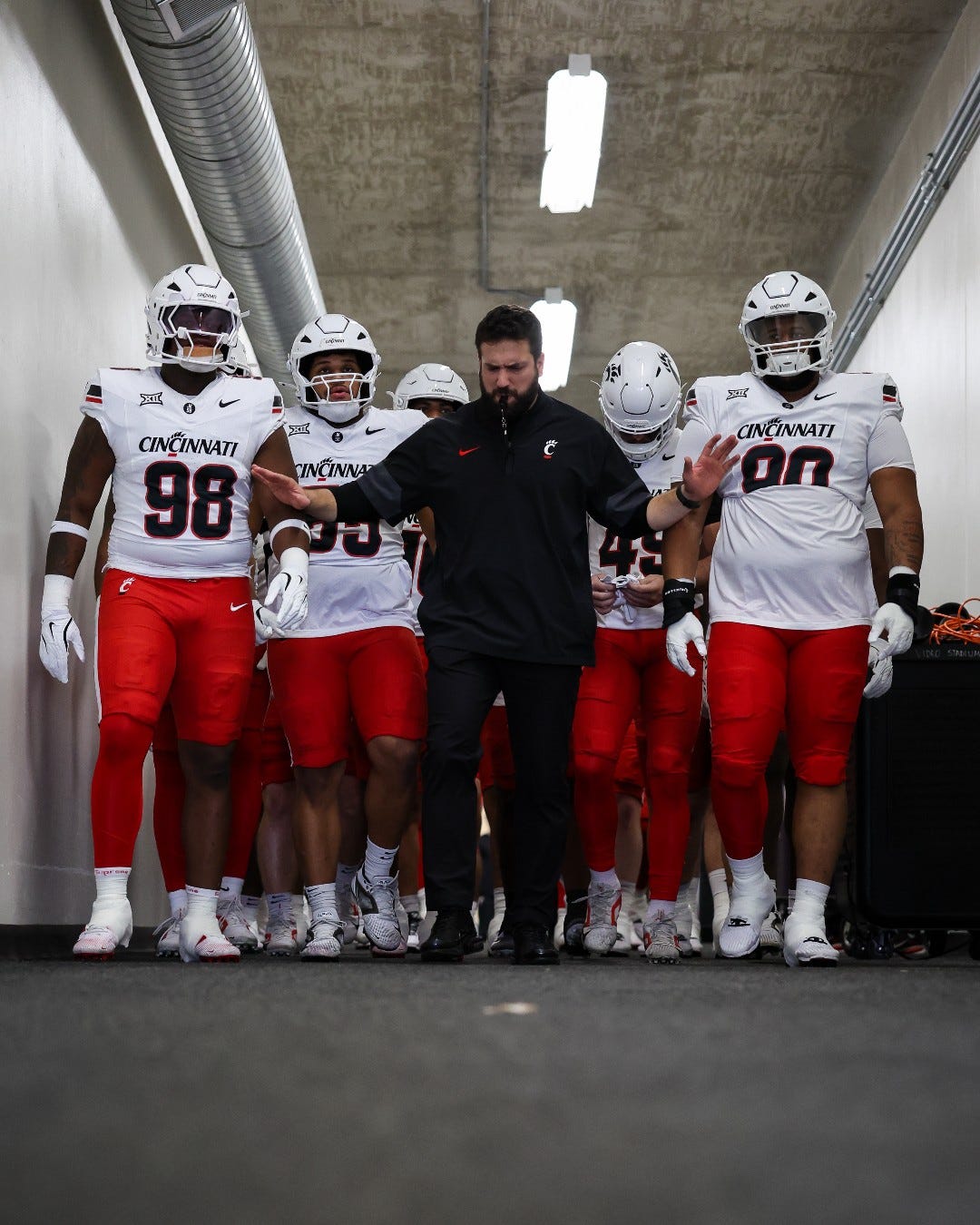 Director of Football Performance Niko Palazeti walks down the tunnel to Amon G. Carter Stadium with the Cincinnati Bearcats as they prepared to face TCU Nov. 29.