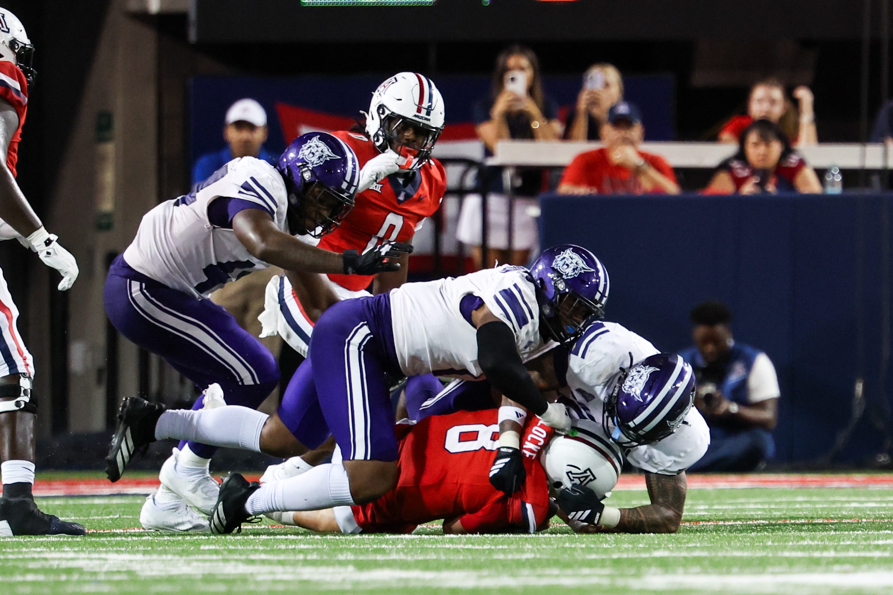Sep 6, 2025; Tucson, Arizona, USA; Weber State Wildcats defensive end Keahnist Thompson (1) sacks Arizona Wildcats quarterback Braedyn Locke (8) during the fourth quarter of the game at Arizona Stadium. Mandatory Credit: Aryanna Frank-Imagn Images
