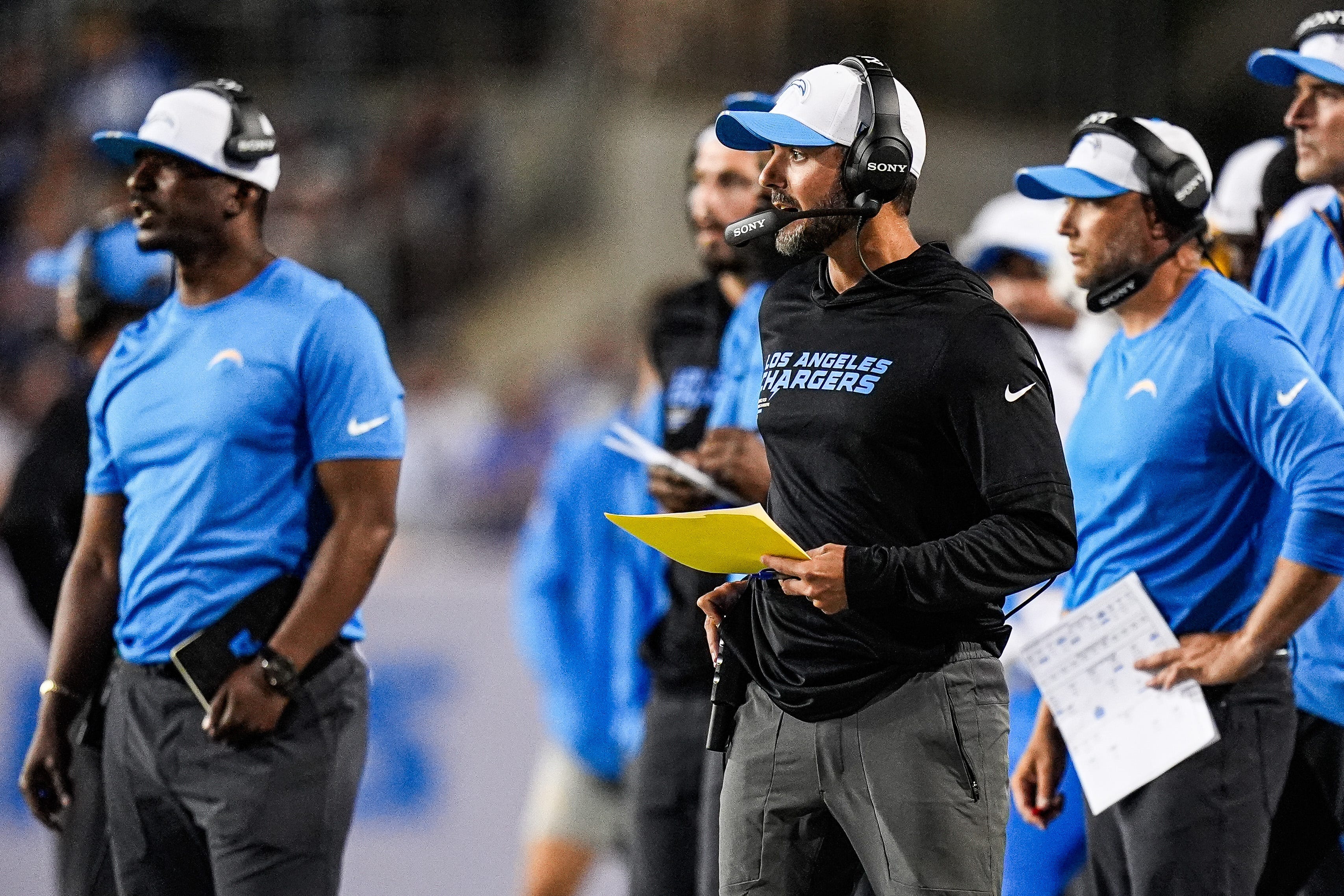 LA Chargers defensive coordinator Jesse Minter, center right, watches a play against Detroit Lions during the first half of the Hall of Fame Game at Tom Benson Hall of Fame Stadium in Canton, Ohio on Thursday, July 31, 2025.