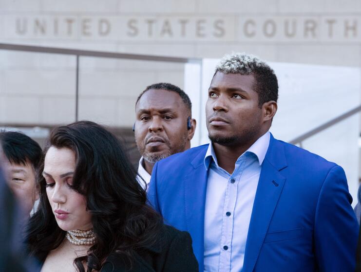 LOS ANGELES, CA - February 11, 2023: Former Dodgers outfielder Yasiel Puig, center, at a news conference outside the federal courthouse in downtown Los Angeles on Saturday February 11, 2023 in Los Angeles, CA. (Brian van der Brug / Los Angeles Times)