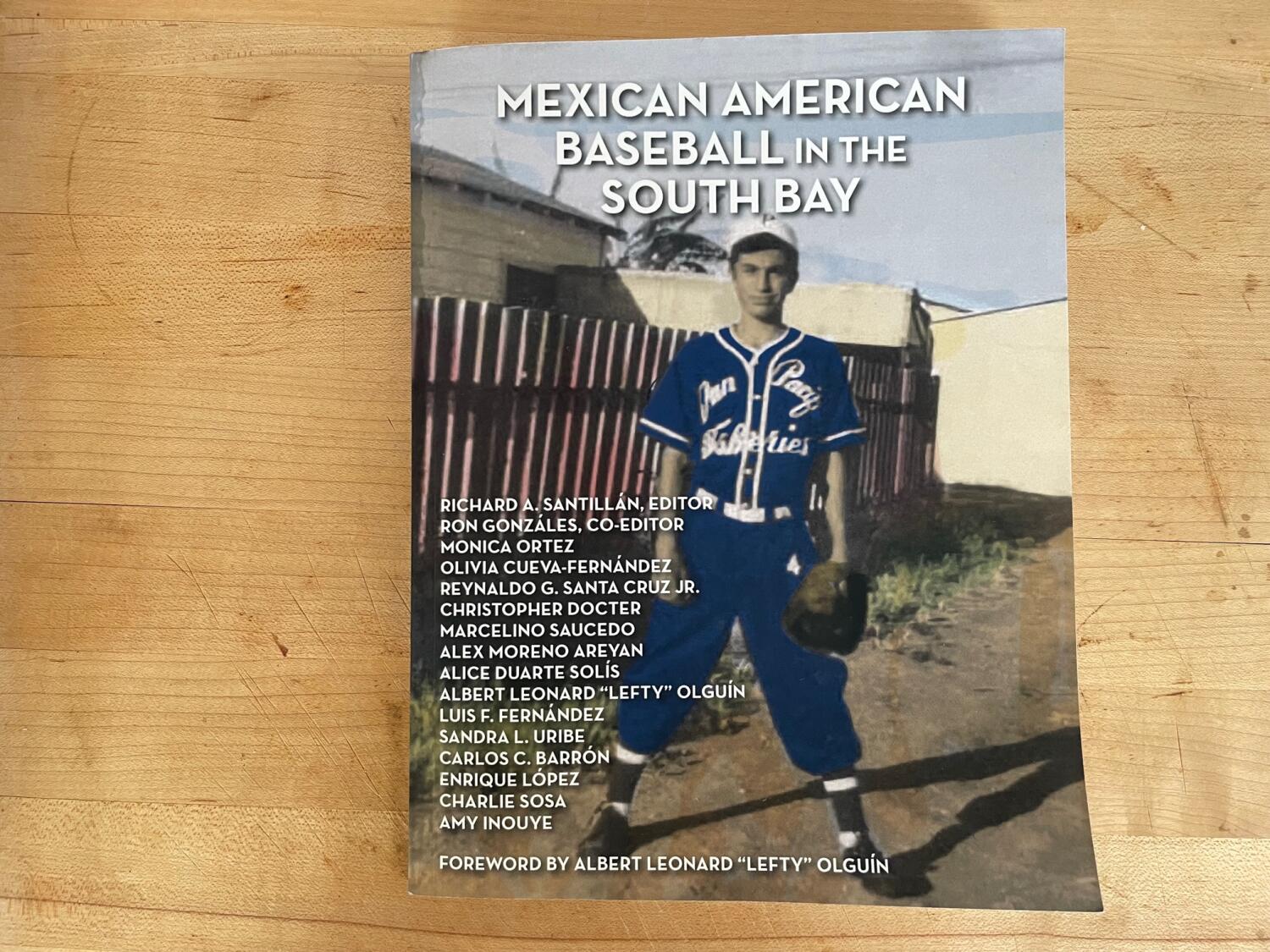 The cover of the book "Mexican American Baseball in the South Bay" features a young Latino baseball player in a yard.