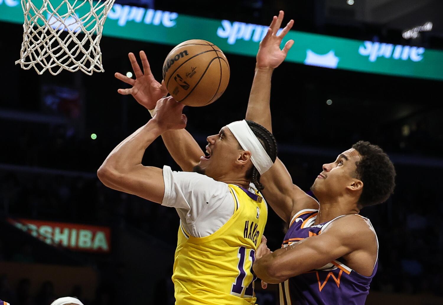 Lakers center Jaxson Hayes battles Suns forward Oso Ighodaro for the ball during the Lakers' loss Monday.