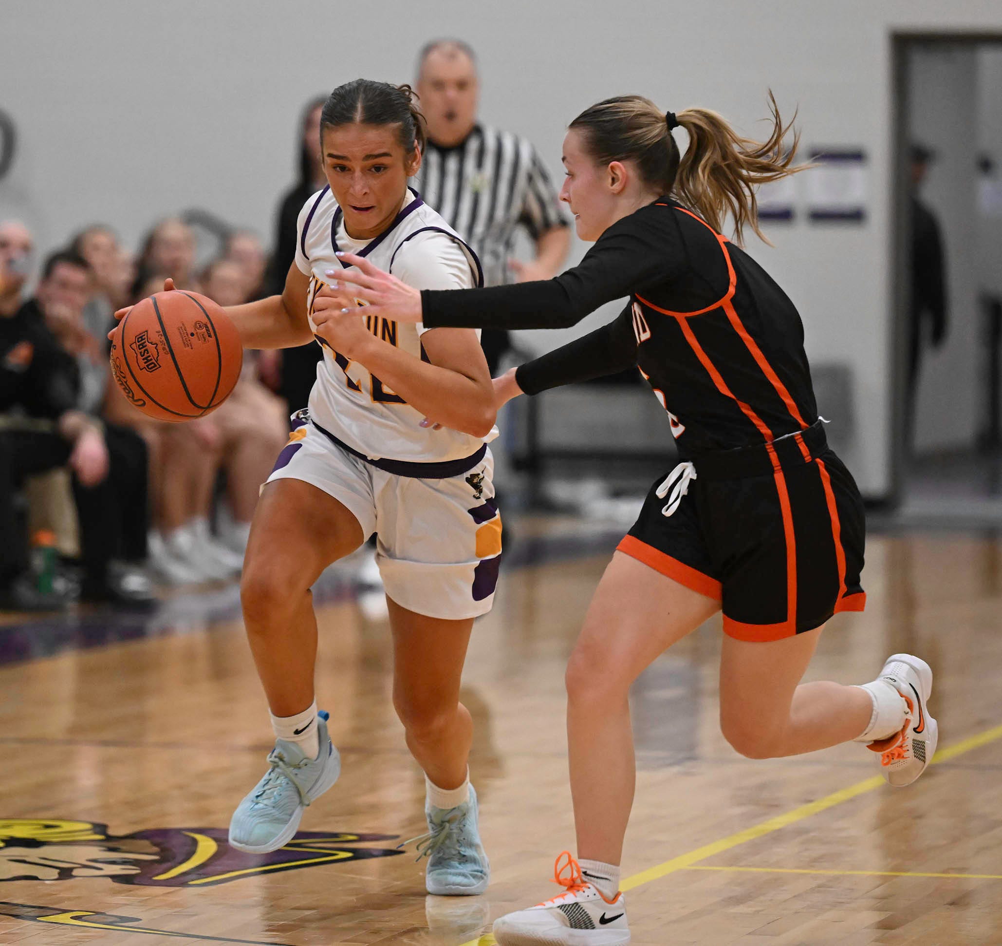 Lexington's Tatum Stover brings the ball up court pressured by Ashland's Grace Tobias.