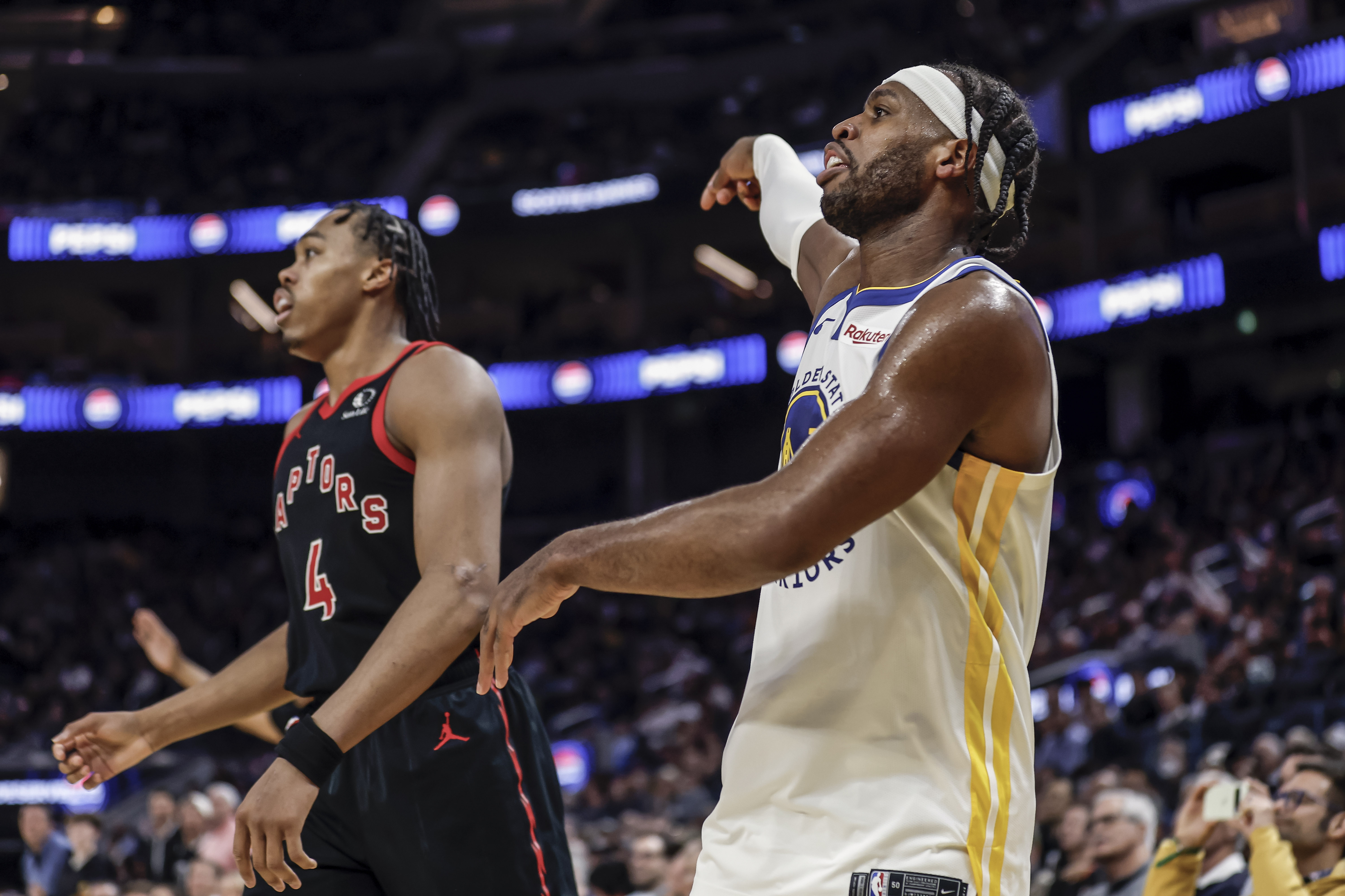 Buddy Hield holding the pose after shooting a three, with Scottie Barnes behind him. 