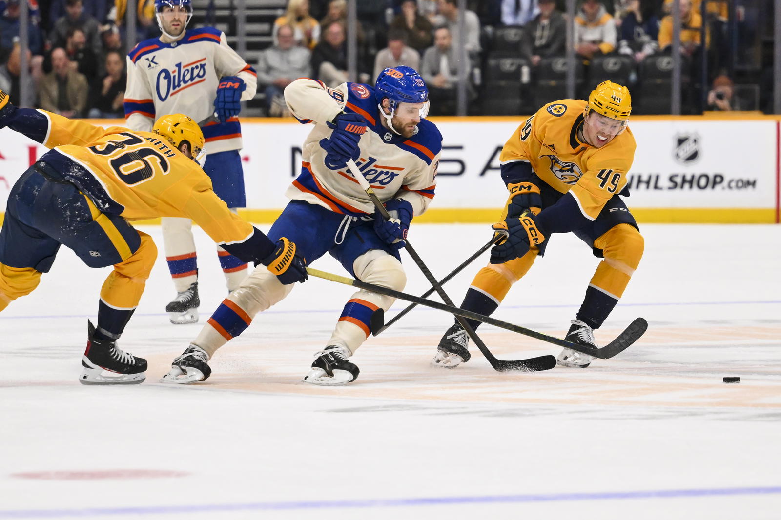Jan 13, 2026; Nashville, Tennessee, USA; Edmonton Oilers center Leon Draisaitl (29) skates past Nashville Predators left wing Cole Smith (36) and left wing Reid Schaefer (49) during the second period at Bridgestone Arena. Mandatory Credit: Steve Roberts-Imagn Images