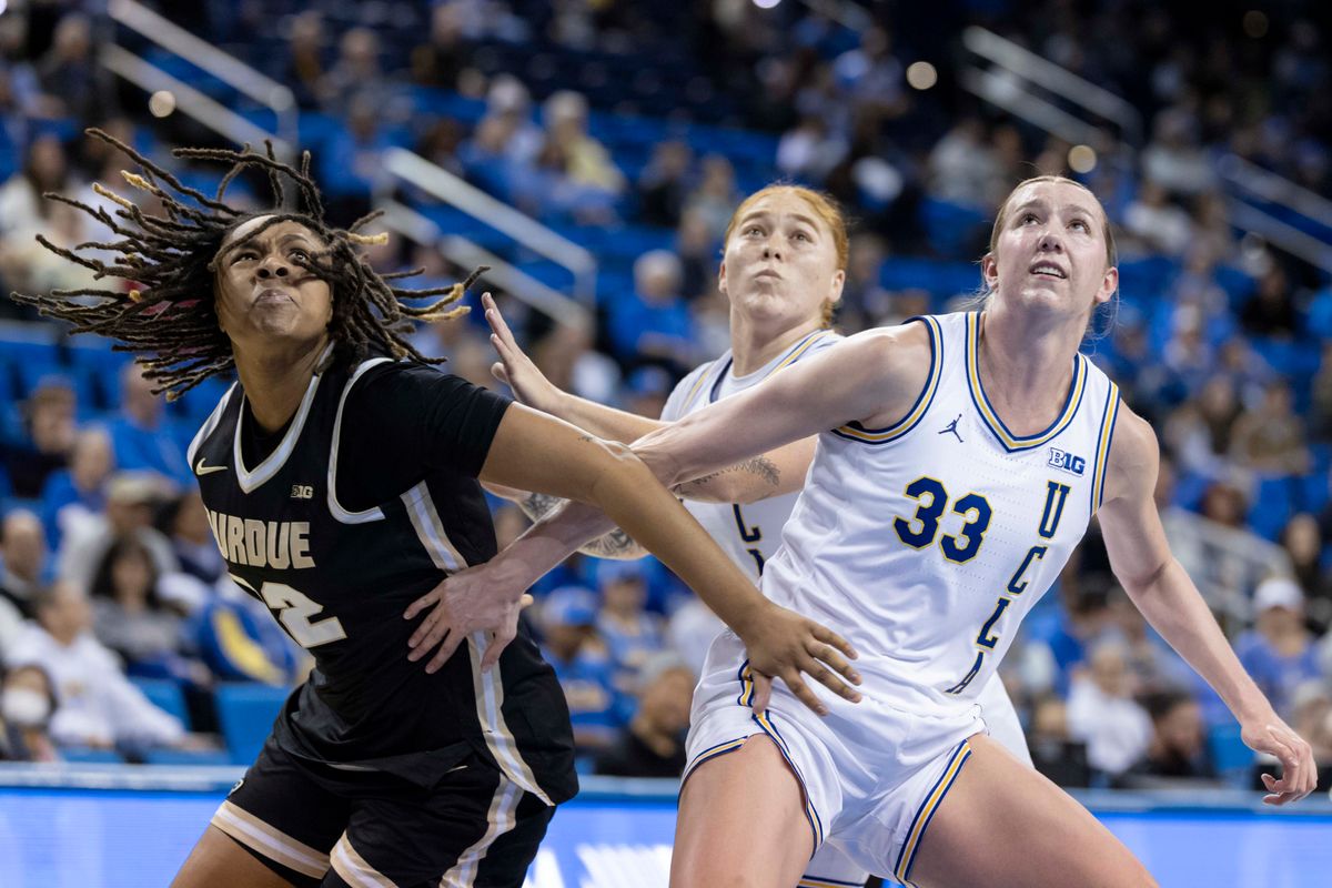 Kendall Puryear #22 of the Purdue Boilermakers and Amanda Muse #33 of the UCLA Bruins fight for a rebound during an NCAA basketball game, Wednesday January 21, 2026 in Los Angeles, Calif.