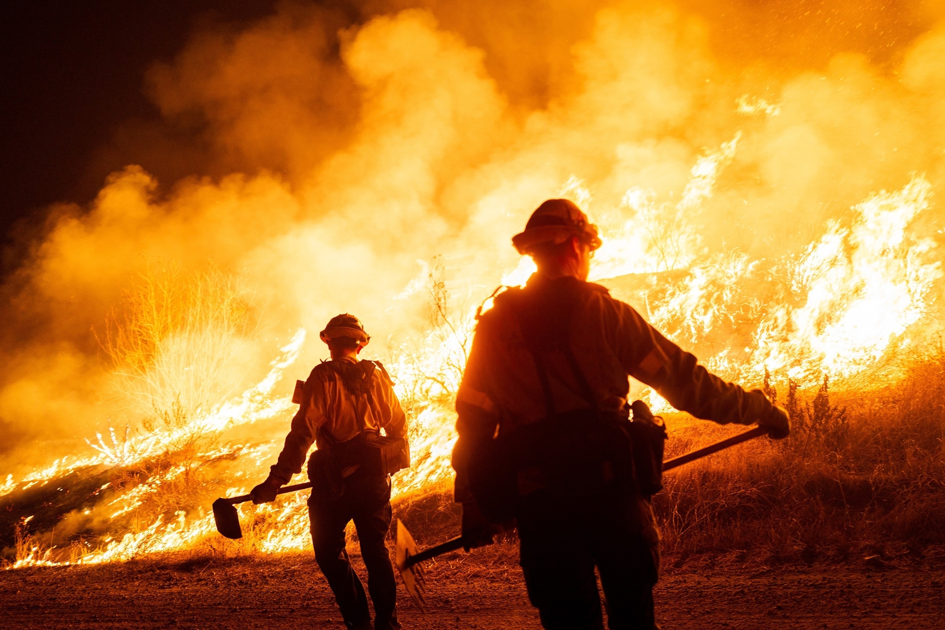 Brandon Bell/Getty Images - PHOTO: Firefighters work as the Hughes Fire burns on January 22, 2025 in Castaic, California.