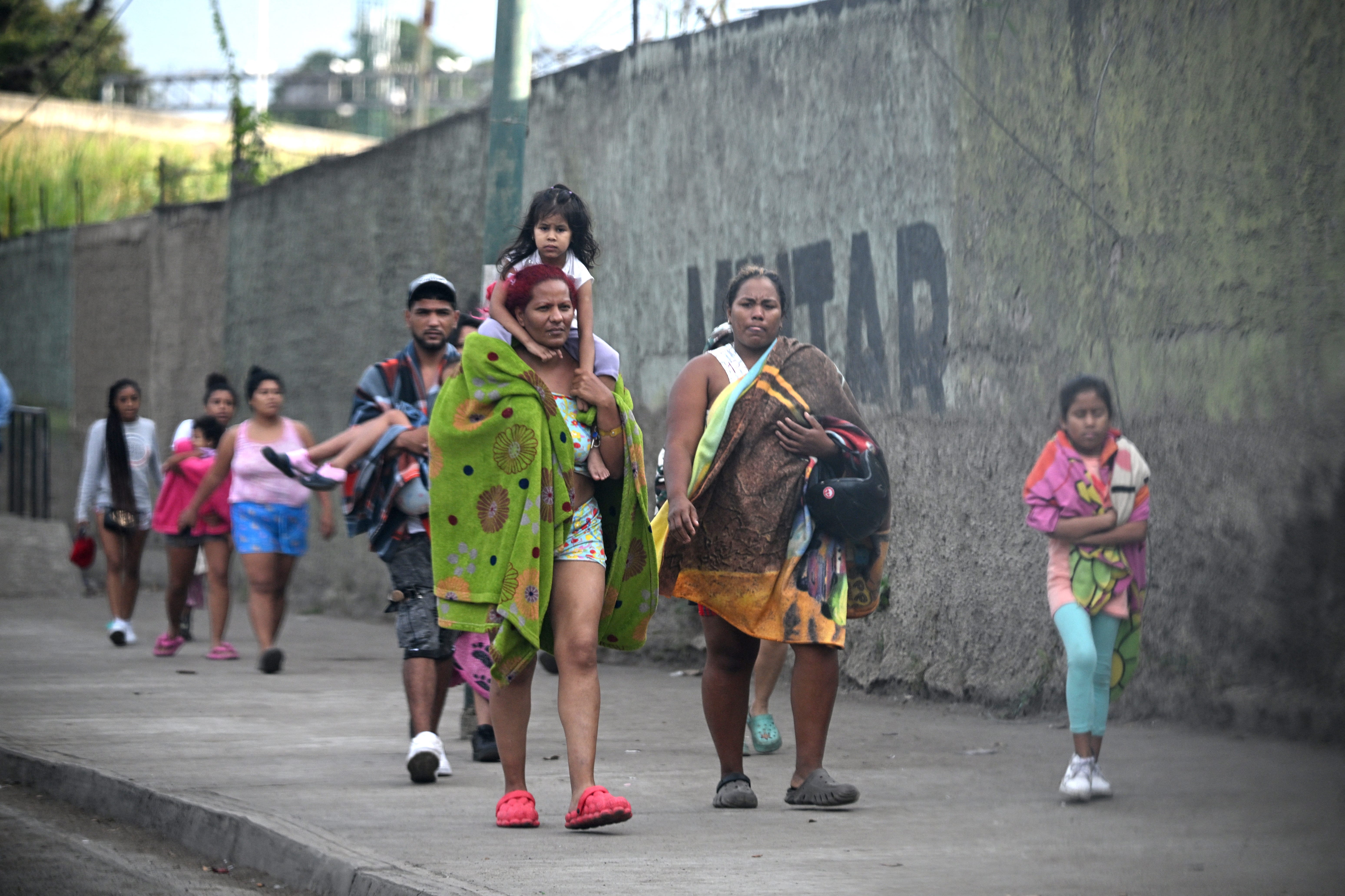 Civilians who were living inside Fuerte Tiuna, Venezuela's largest military complex leave the compound, in Caracas on Jan. 3, 2026.