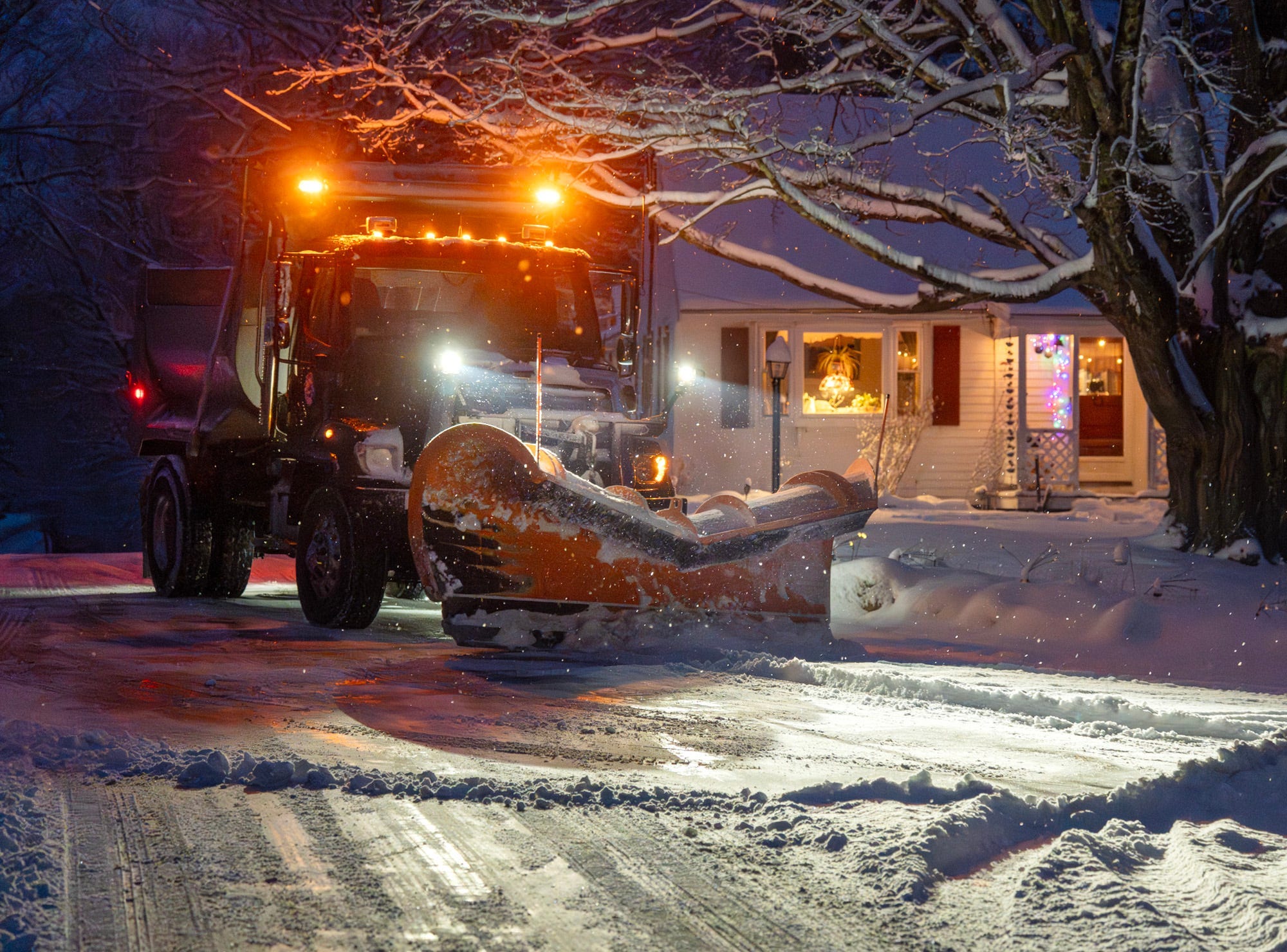 A town snow plow clears an intersection in Ashburnham, Mass. on Jan. 18, 2026. Ashburnham received 7 inches of snow, according to the National Weather Service.