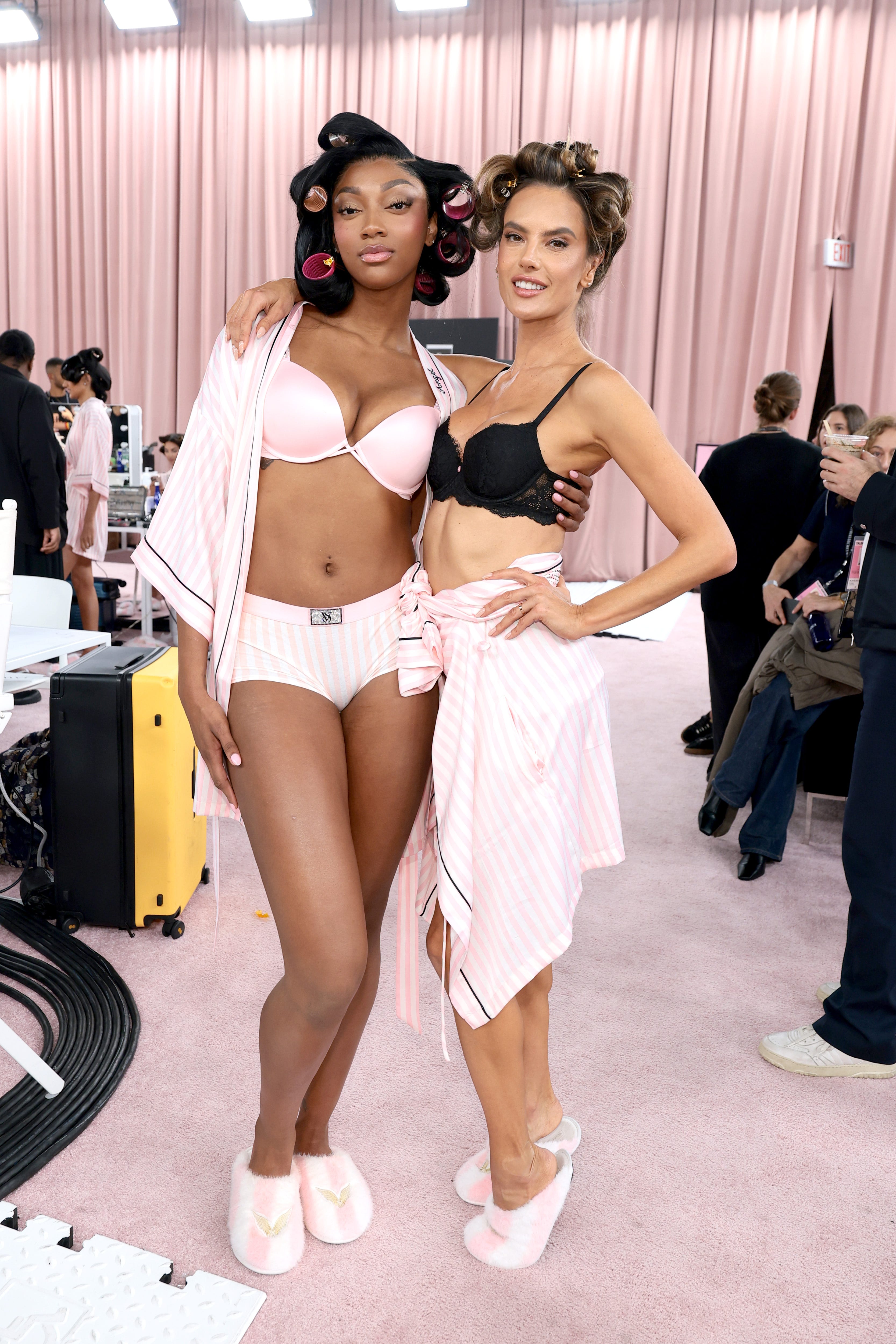 Angel Reese and Alessandra Ambrosio prepare backstage for the Victoria's Secret Fashion Show in New York on Oct. 15.